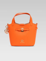 Load image into Gallery viewer, Front view of delphine bucket bag in orange color