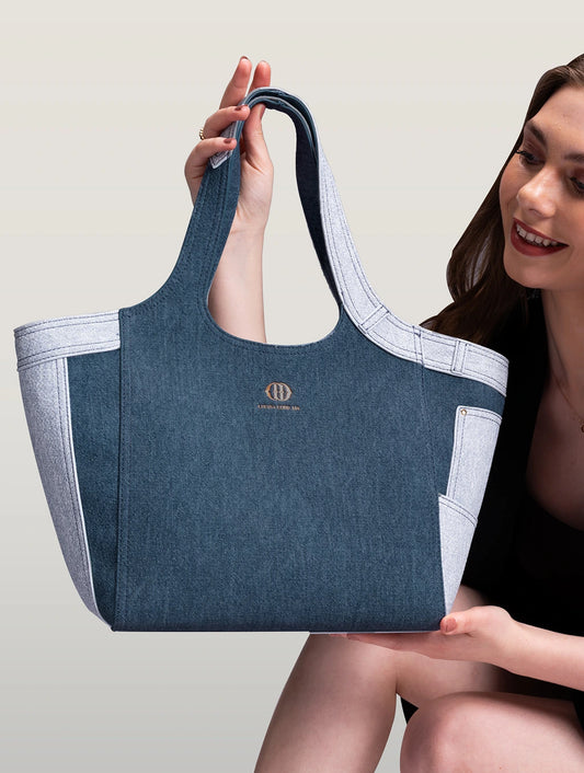 A model holding a Marlene dark blue demin tote bag