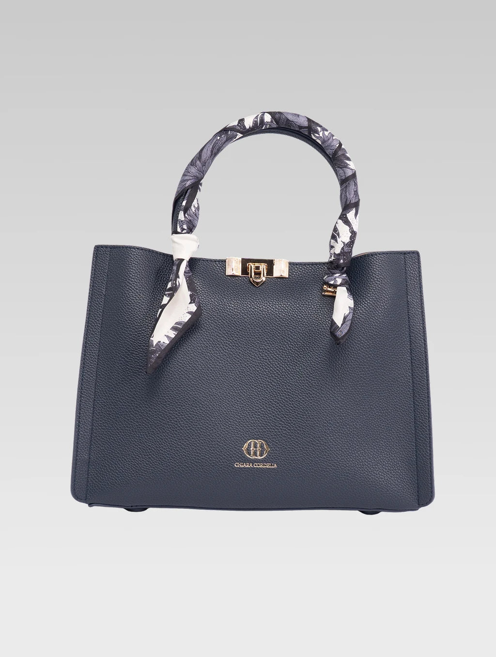 Front view of alessia tote bag in bark blue color and white clothe beaded to it's handle