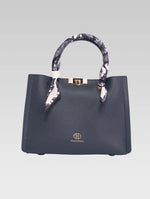 Load image into Gallery viewer, Front view of Alessia Tote bag in Bark Blue color and white clothe beaded to it's handle
