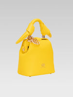 Load image into Gallery viewer, Side view of caledonia frame bag in yellow color
