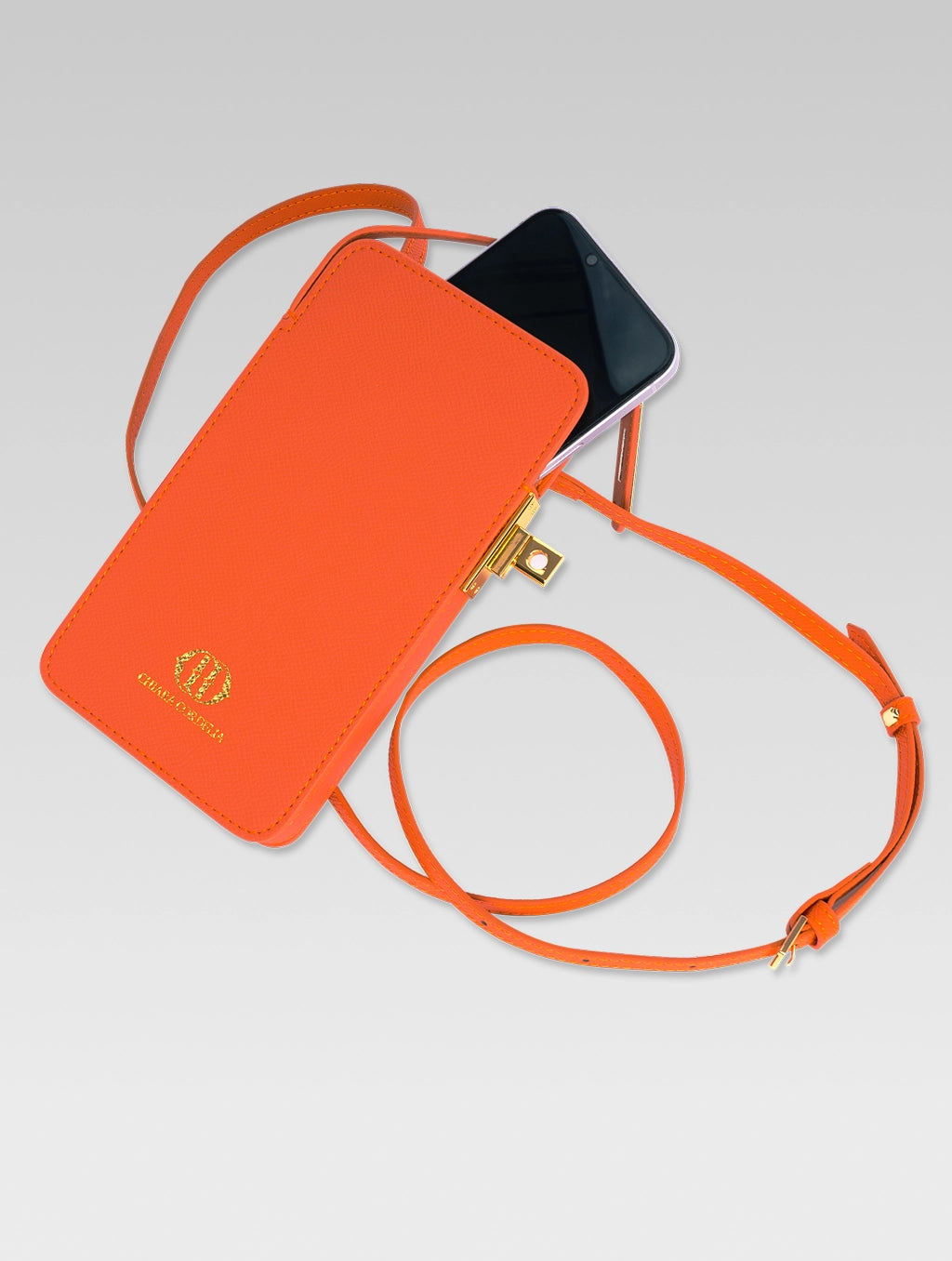 Sixtine - phone popping out of orange color phone bag with lock