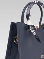 Load image into Gallery viewer, Side view of Alessia Tote bag in Bark Blue color and white clothe beaded to it's handle
