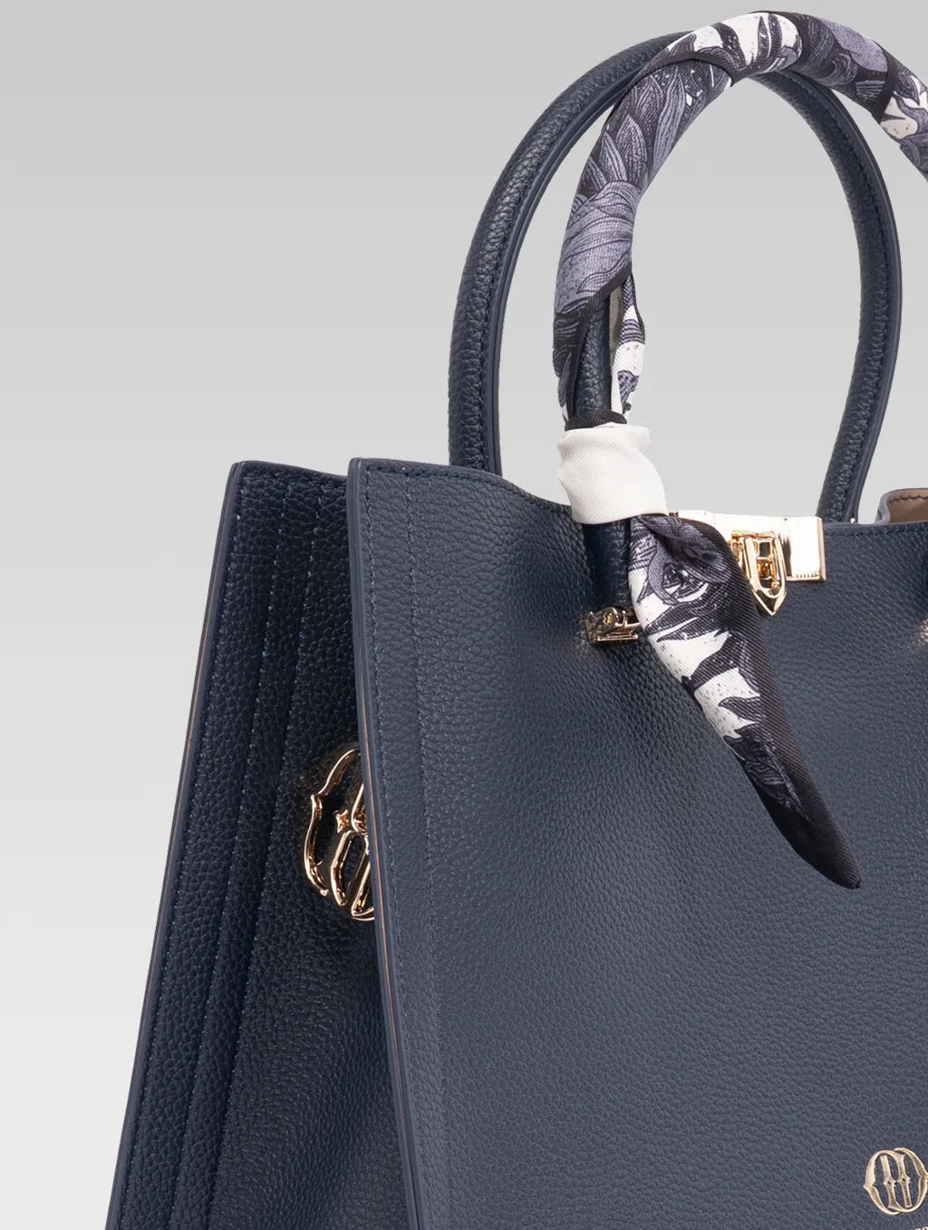 Side view of Alessia Tote bag in Bark Blue color and white clothe beaded to it's handle