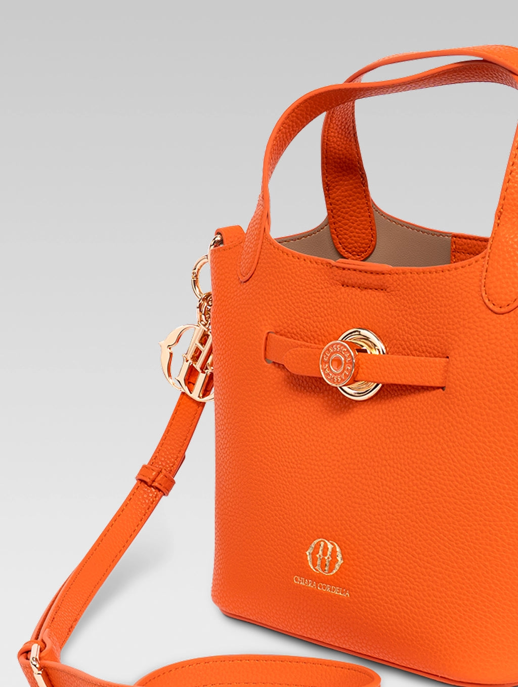 Side view of delphine bucket bag in orange color
