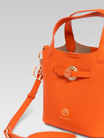Load image into Gallery viewer, Side view of delphine bucket bag in orange color
