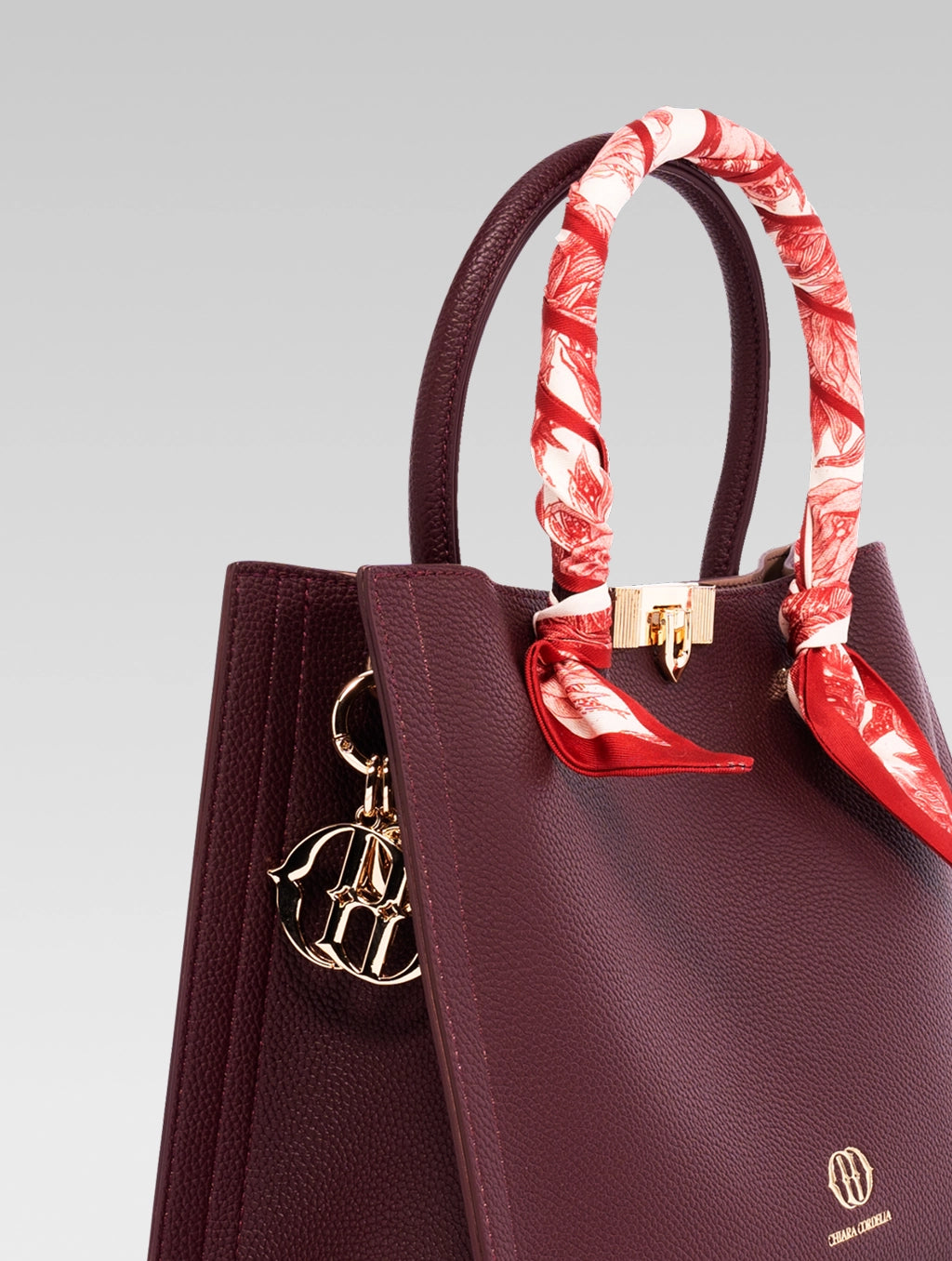 Side view of Alessia Tote bag in Wine Red color with a red and white clothe beaded to it's handle