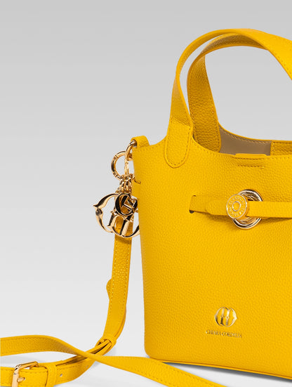 Side view of delphine bucket bag in yellow color with shoulder strap