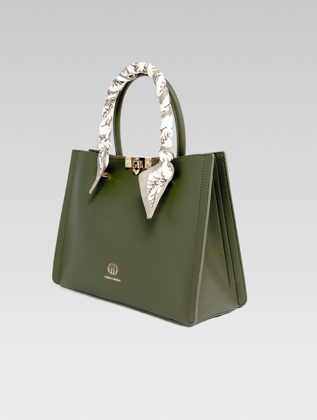 Side view of Alessia Tote bag in British Green color and white clothe beaded to it's handle
