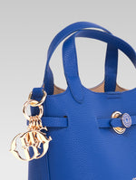 Load image into Gallery viewer, Side view of delphine bucket bag in blue color
