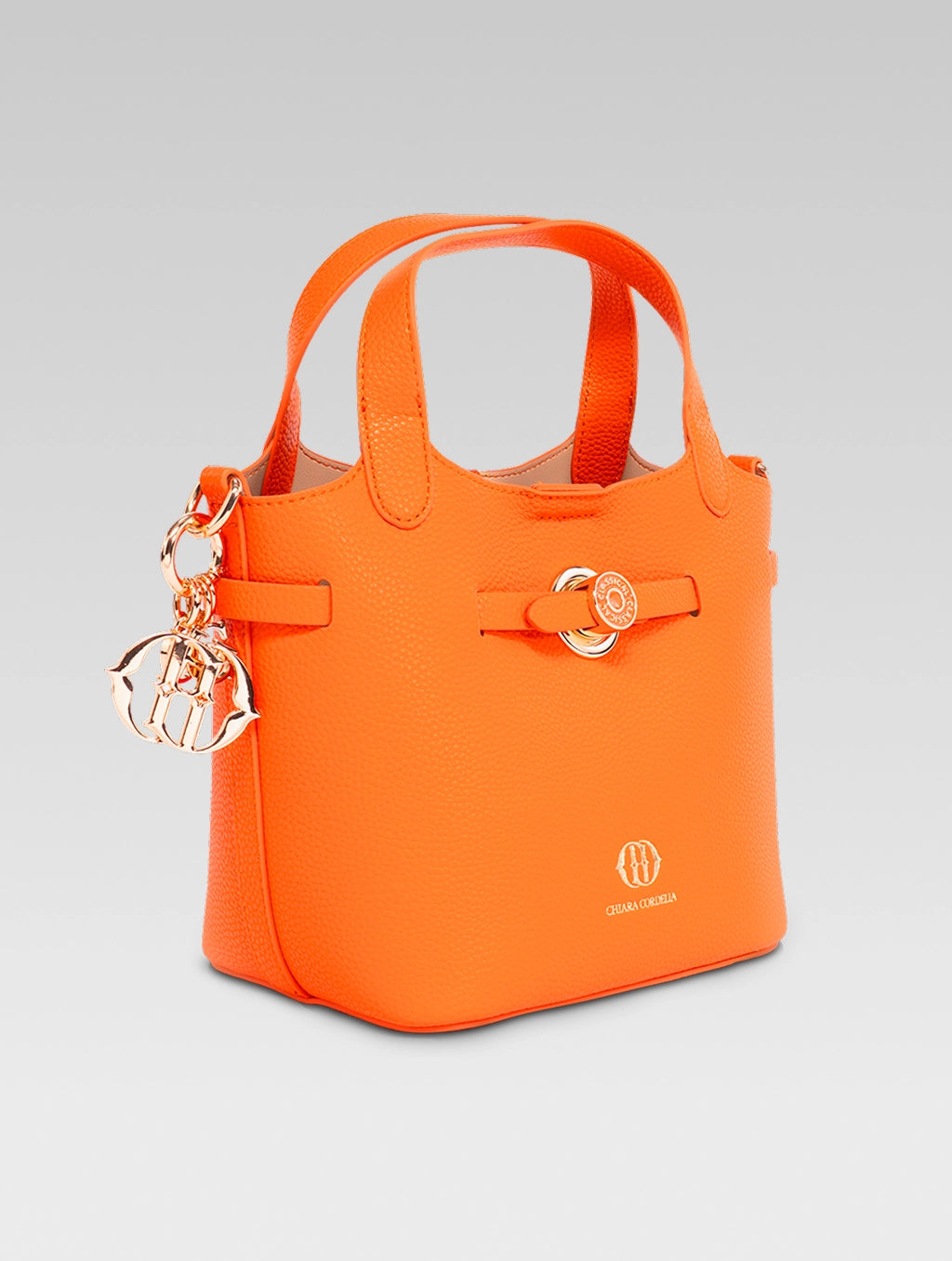 Left side view of delphine bucket bag in orange color
