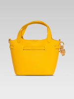 Load image into Gallery viewer, Back view of delphine bucket bag in yellow color
