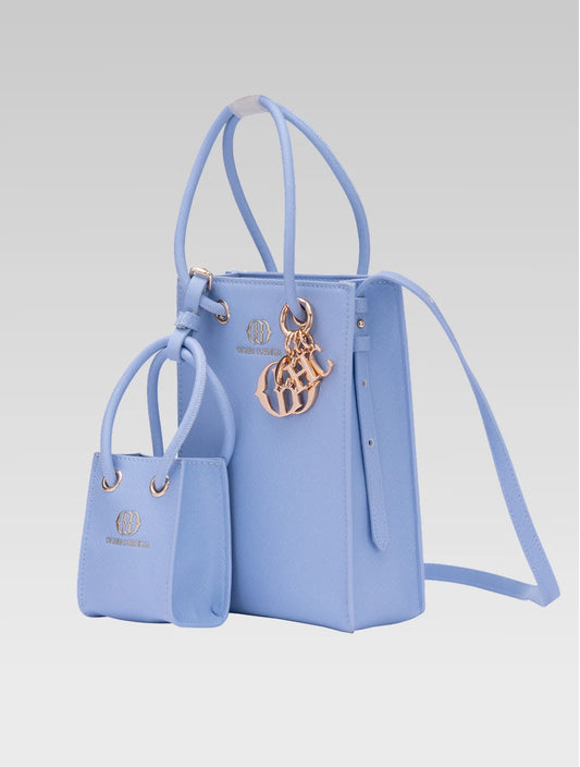 Side view of genevieve bucket bag in baby blue color and a mini tote bag