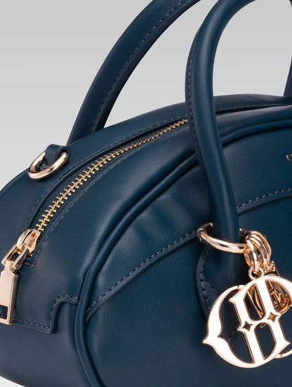 Side closeup view of emberly envelope bag handle in royal teal color