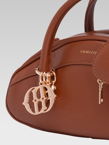 Side closeup view of emberly envelope bag handle in tan color