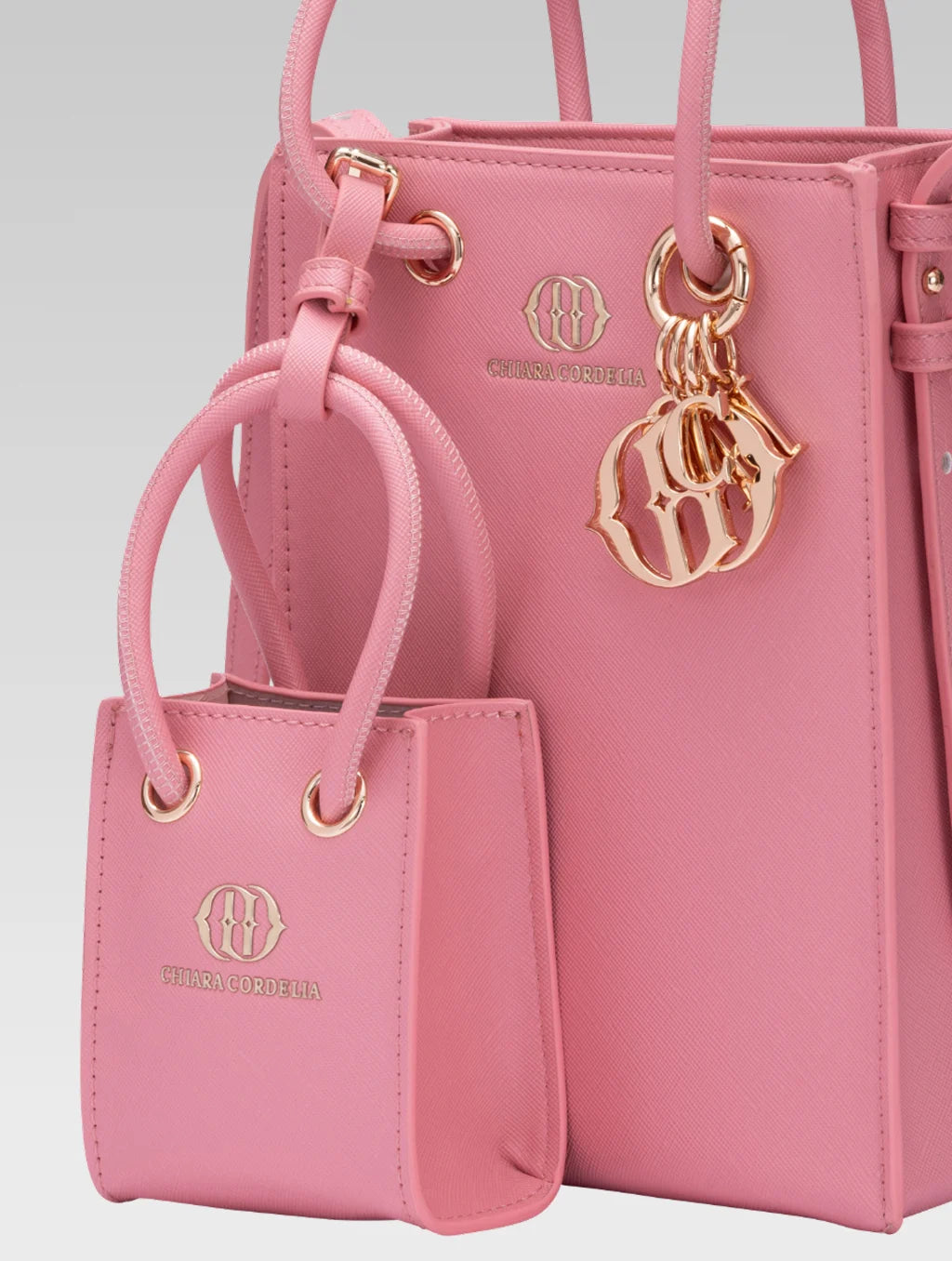Cropped side view of Genevieve Bucket bag in Baby pink color and a mini tote bag