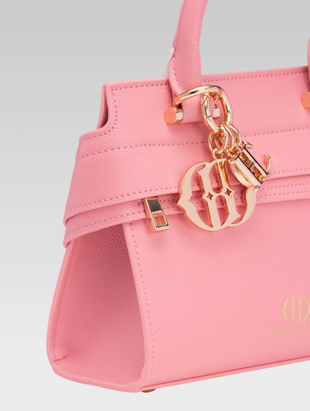 Side closeup view of ophelia envelope bag handle in baby pink color