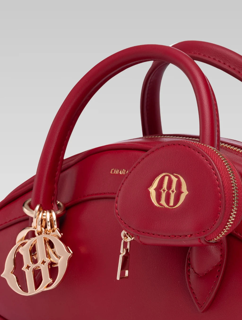 Side closeup view of emberly envelope bag handle in red color