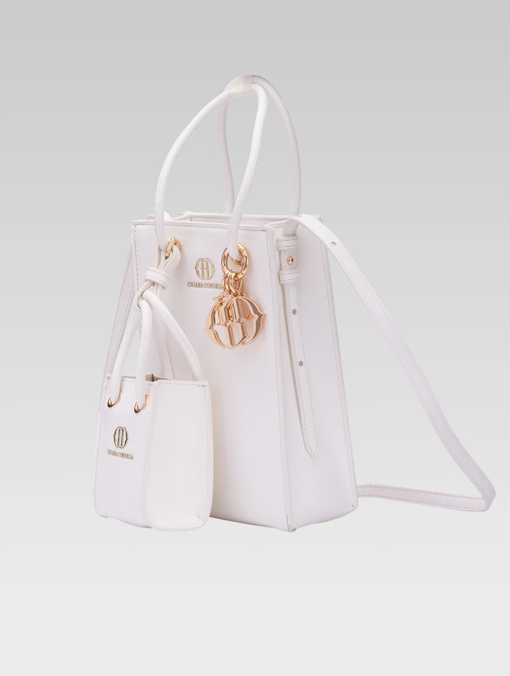 Side view of Genevieve Bucket bag in white color and a mini tote bag