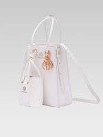 Load image into Gallery viewer, Side view of Genevieve Bucket bag in white color and a mini tote bag
