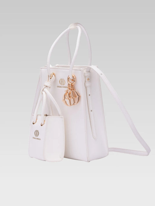 Side view of Genevieve Bucket bag in white color and a mini tote bag