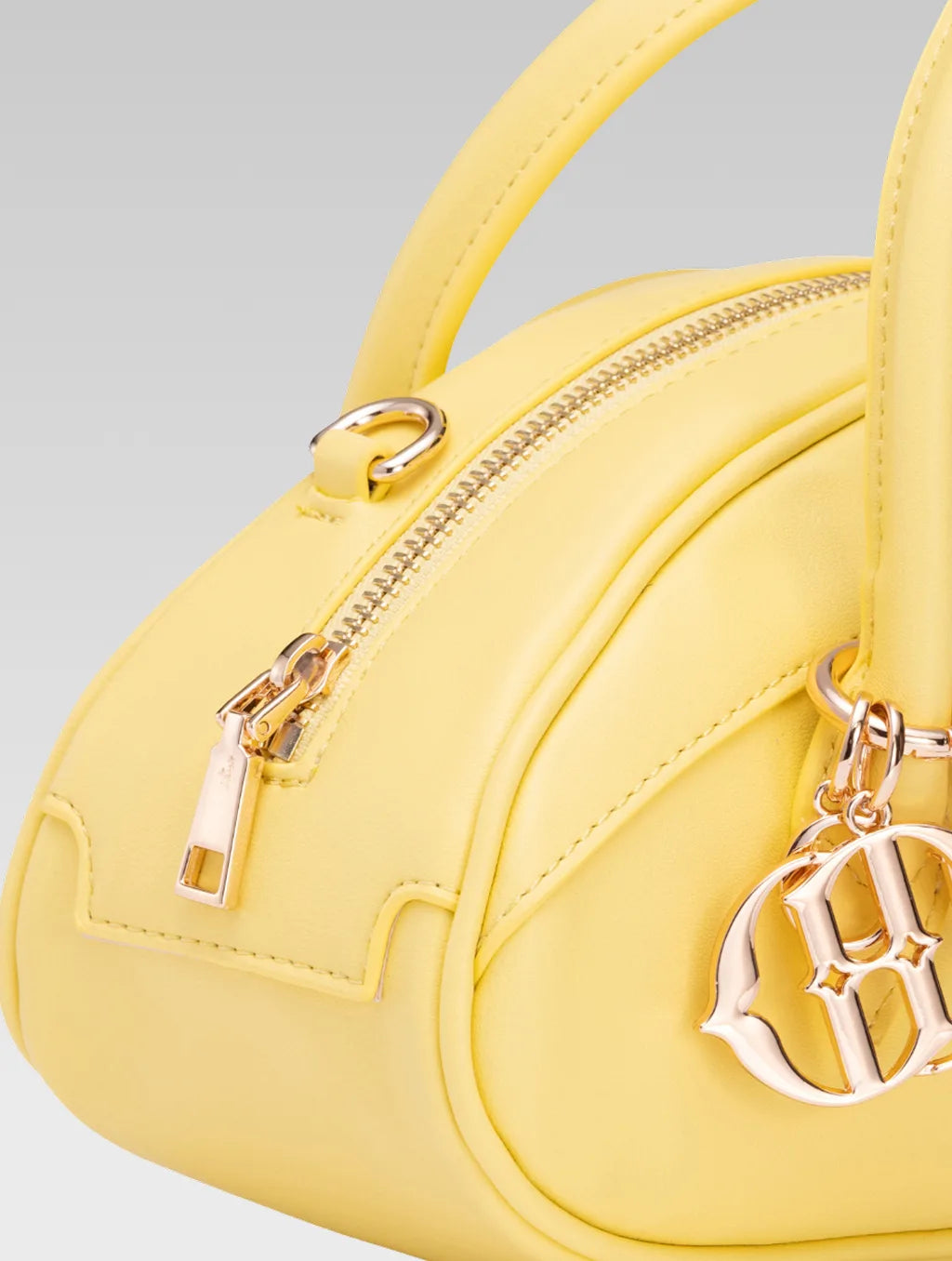 Side closeup view of emberly envelope bag handle in yellow color