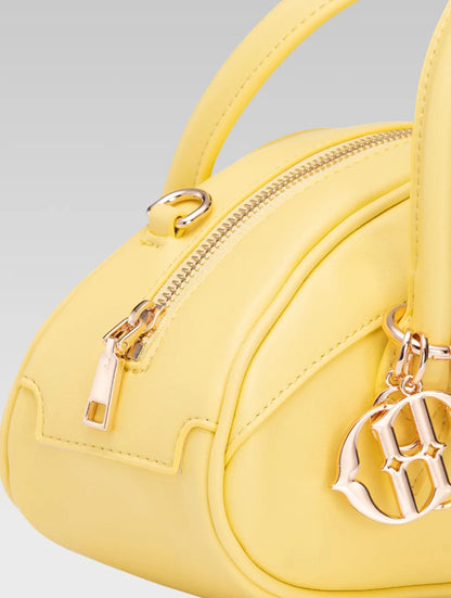 Side closeup view of emberly envelope bag handle in yellow color
